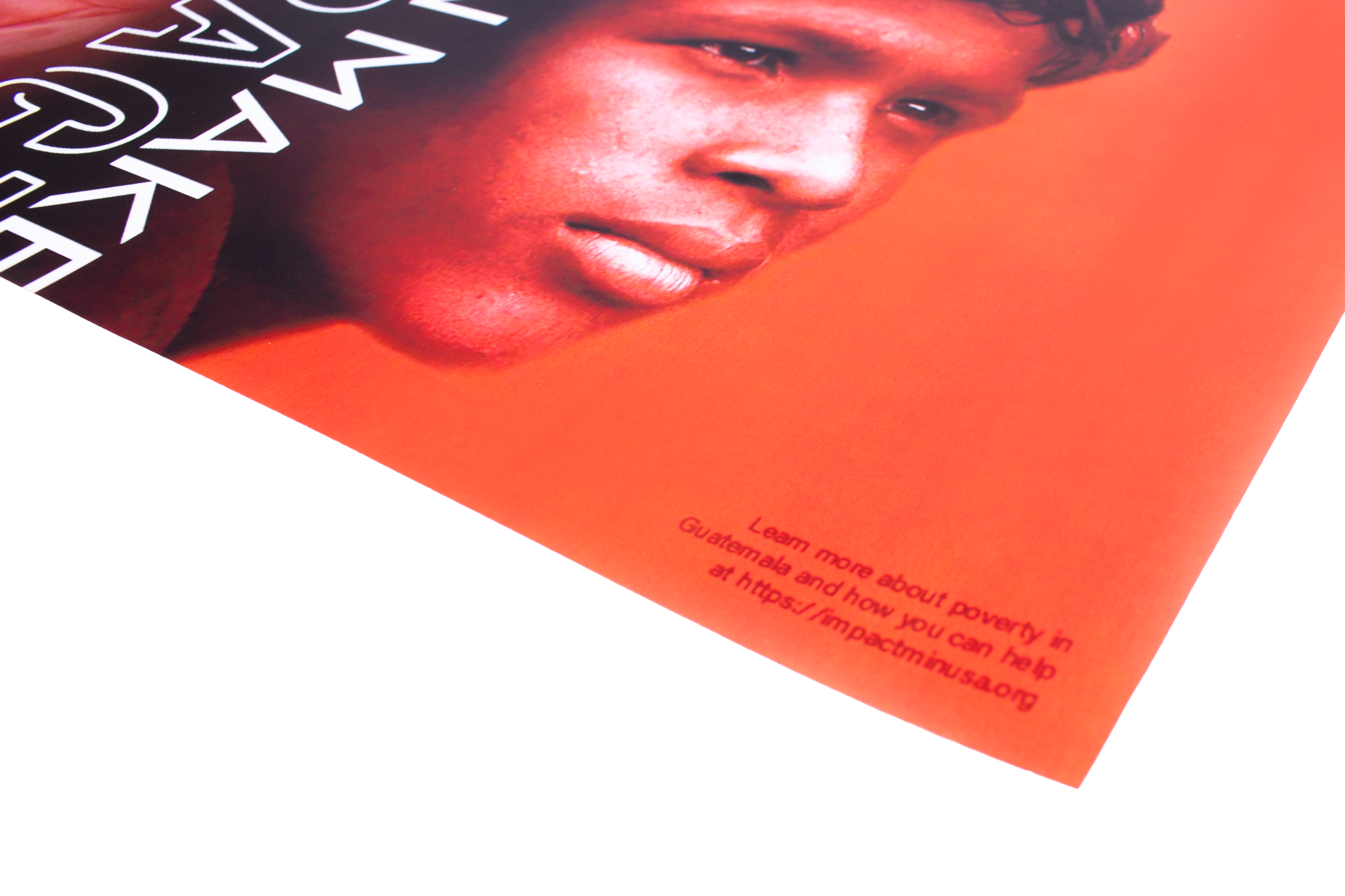 Close-up of the printed poster showing the outlined headline, photography, and website call to action